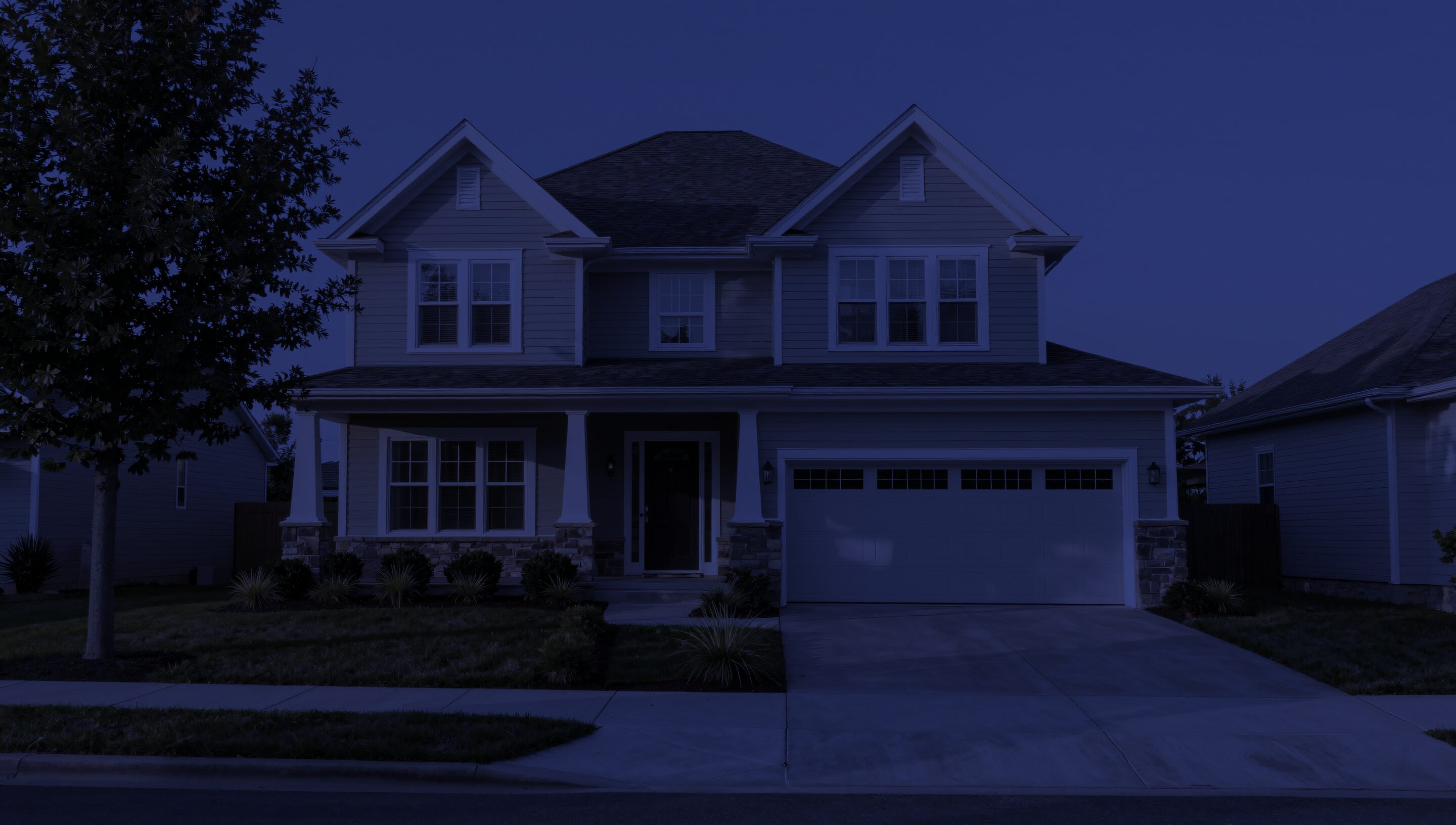 A house on a cold, still night, every window dark.