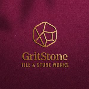 GritStone Tile & Stone Works logo foil-stamped on maroon paper