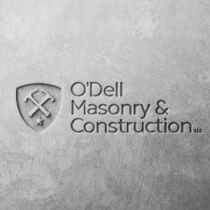 O'Dell Masonry & Construction logo engraved in a concrete wall