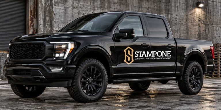 Stampone Construction & Home Improvement logo on the door of a black pickup truck